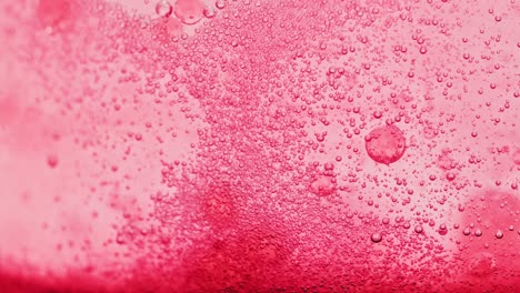 macro-shot-of-bright-red-water-with-many-sparkling-bubbles