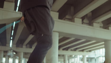 male athlete having jump rope workout outdoors in city