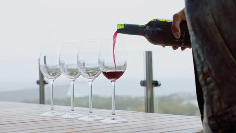 bottle-of-red-wine-pouring-into-glass-celebrating-luxury-fine-dining