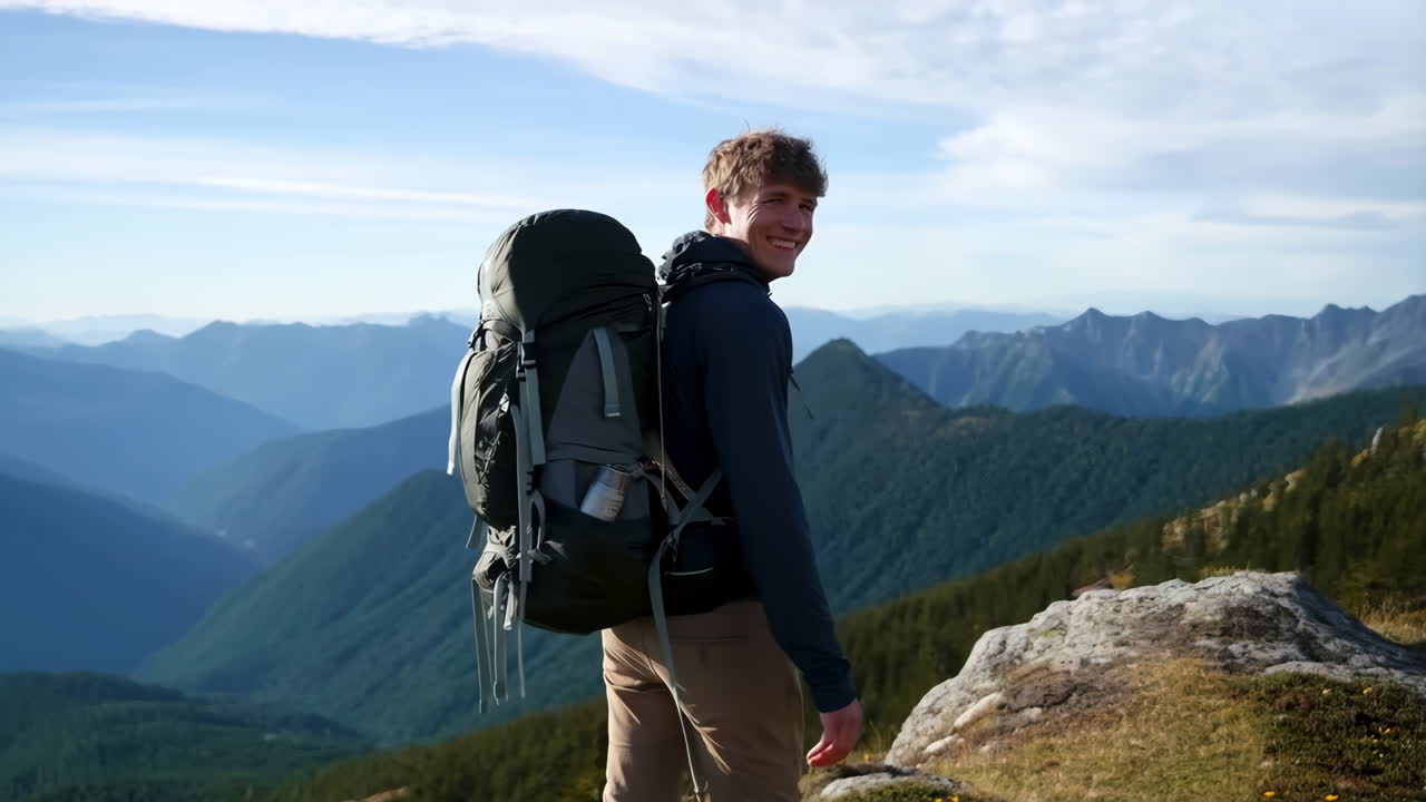 Hiker on a Mountain Ridge Overlooking a Vast Landscape