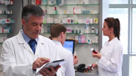 senior pharmacist using tablet pc