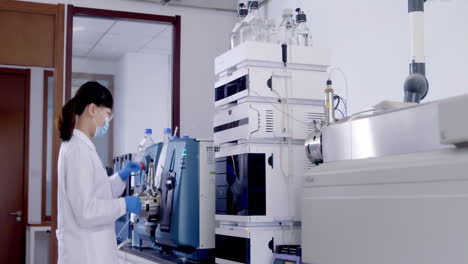 medical worker in lab coats conducting biological experiment with automated machinery equipment. forensic exam in lab or pharma, genetics, innovation in medicine for detection of antibodies infections
