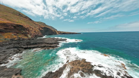 fpv drone flies over rocky cliffs of la fajana, capturing ocean waves