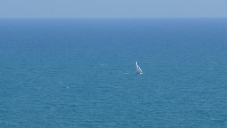 a small sailboat sailing through the mediterranean