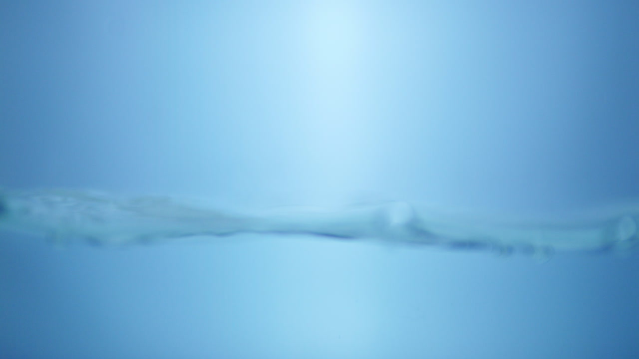 Close-up of water surface with ripples on a blue background