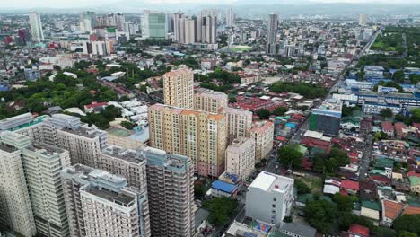 rising drone shot over residential high rises in quezon city, philippines