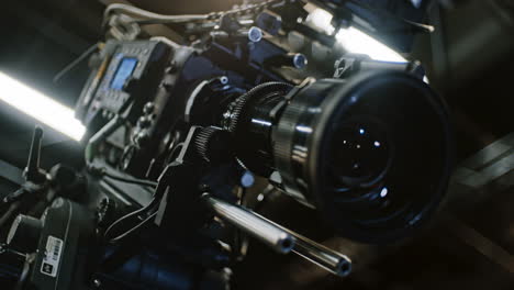 toma de ángulo bajo de una cámara de cine profesional y lente de zoom telefoto larga, el dispositivo remoto está girando los engranajes y el elemento de la lente se está moviendo para cambiar la distancia focal