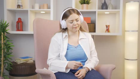 happy young woman listening to music with headphones.