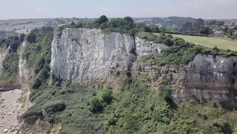 drone jib sobre la costa jurásica revelando un vasto campo con aldeas y casas