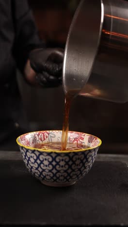 chef preparing a bowl of soup