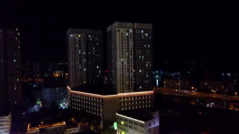 night cityscape with illuminated skyscrapers and highway