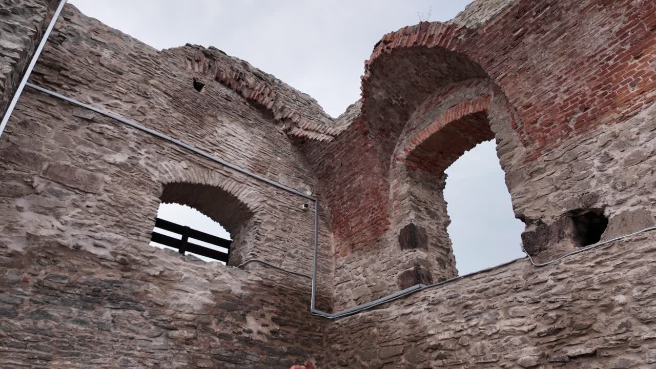 Ancient stone fortress wall in Deva, Romania, with visible details of the old construction and historic heritage