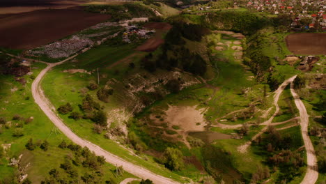 Beautiful-Aerial-Drone-Shot-of-Clouds-Moving-Across-Green-Meadow-in-Moldova-Romania