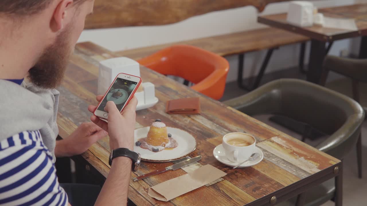 카페에서 디저트의 사진을 찍는 남자