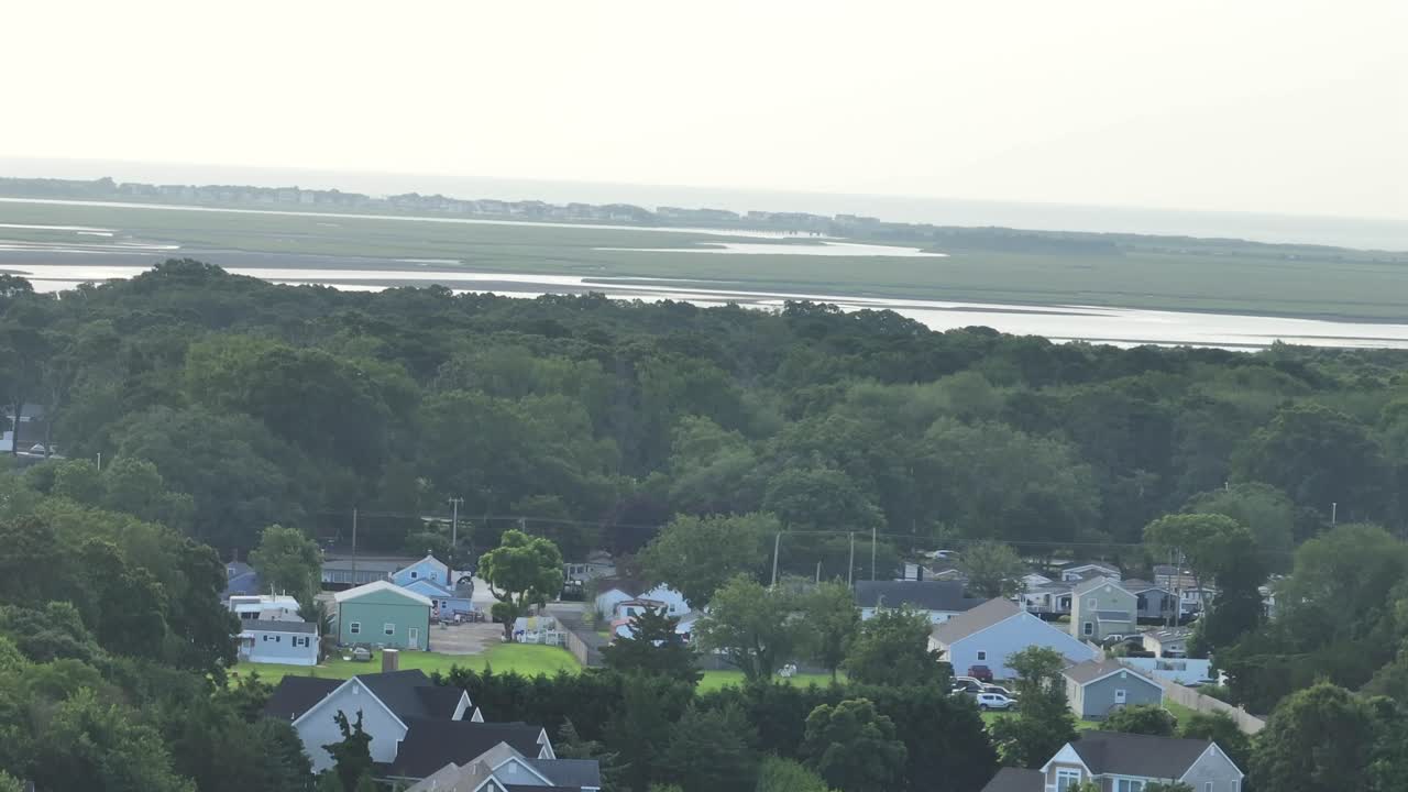 American neighborhood houses in suburb of ocean. Cloudy sunrise in the morning. Aerial rising wide shot. Stone harbor, New Jersey, USA. Beach houses in American town