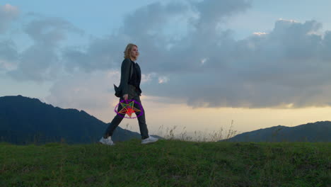 Slow-motion-shot-of-a-woman-holding-a-star-lantern-whilst-walking-in-the-hillside