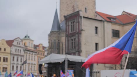 czech flag waving on protest in prague old town, slow motion