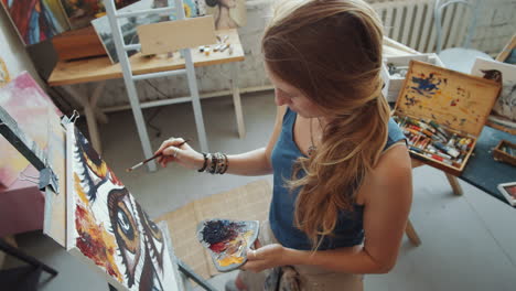 woman artist painting in studio