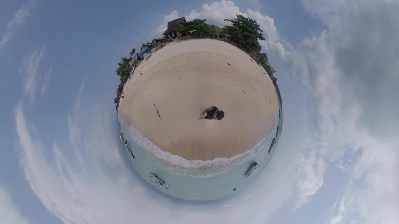 Person on a tropical beach with boats