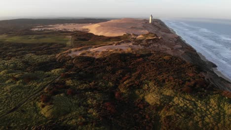 a lighthouse on sand dunes in northern denmark