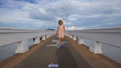 girl walking on a pier