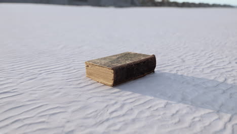 old-book-on-the-sand-beach