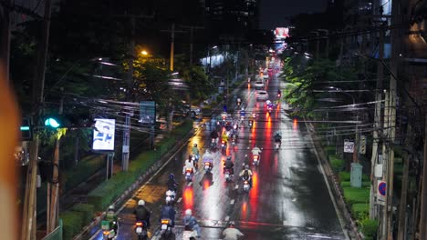 rainy night city street with motorbikes