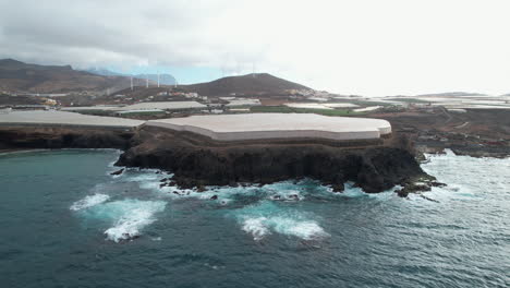 Wonderful-aerial-shot-approaching-the-greenhouses-on-the-coast-of-Punta-de-Galdar