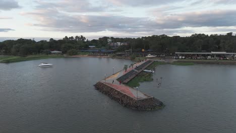 Aerial-view-of-people-walking-on-the-pier-in-the-evening