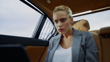 Focused-woman-looking-computer-screen-at-car.-Businesswoman-getting-upset