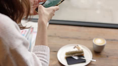 woman using phone in a cafe