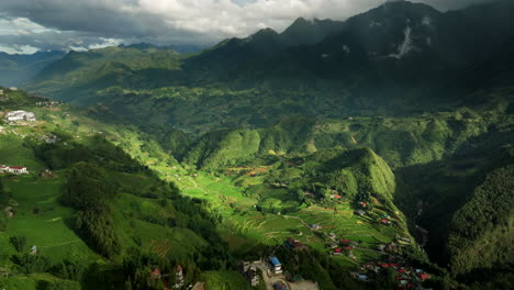 aerial view of village settlements down the lush hoang lien son mountains of northwestern vietnam.