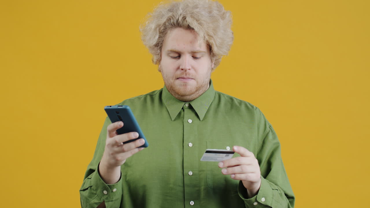 Man using mobile phone and credit card