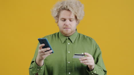 man using mobile phone and credit card