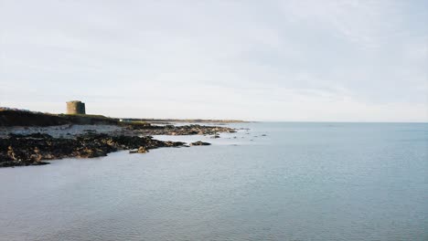 the beautiful rocky shore in balbriggan with a few of people walking around