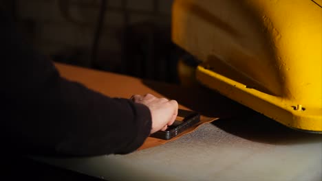 leather cutting process with machinery and hands
