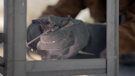 close up of welder using stick welder, slow motion pull back shot