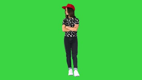 asian girl in casual outfit standing with folded hands on a green screen, chroma key