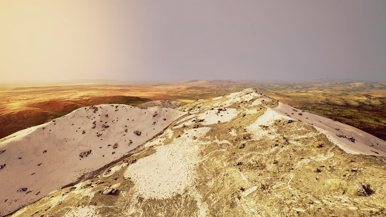 Vast desert landscape showcasing rolling dunes and colorful terrain at dusk