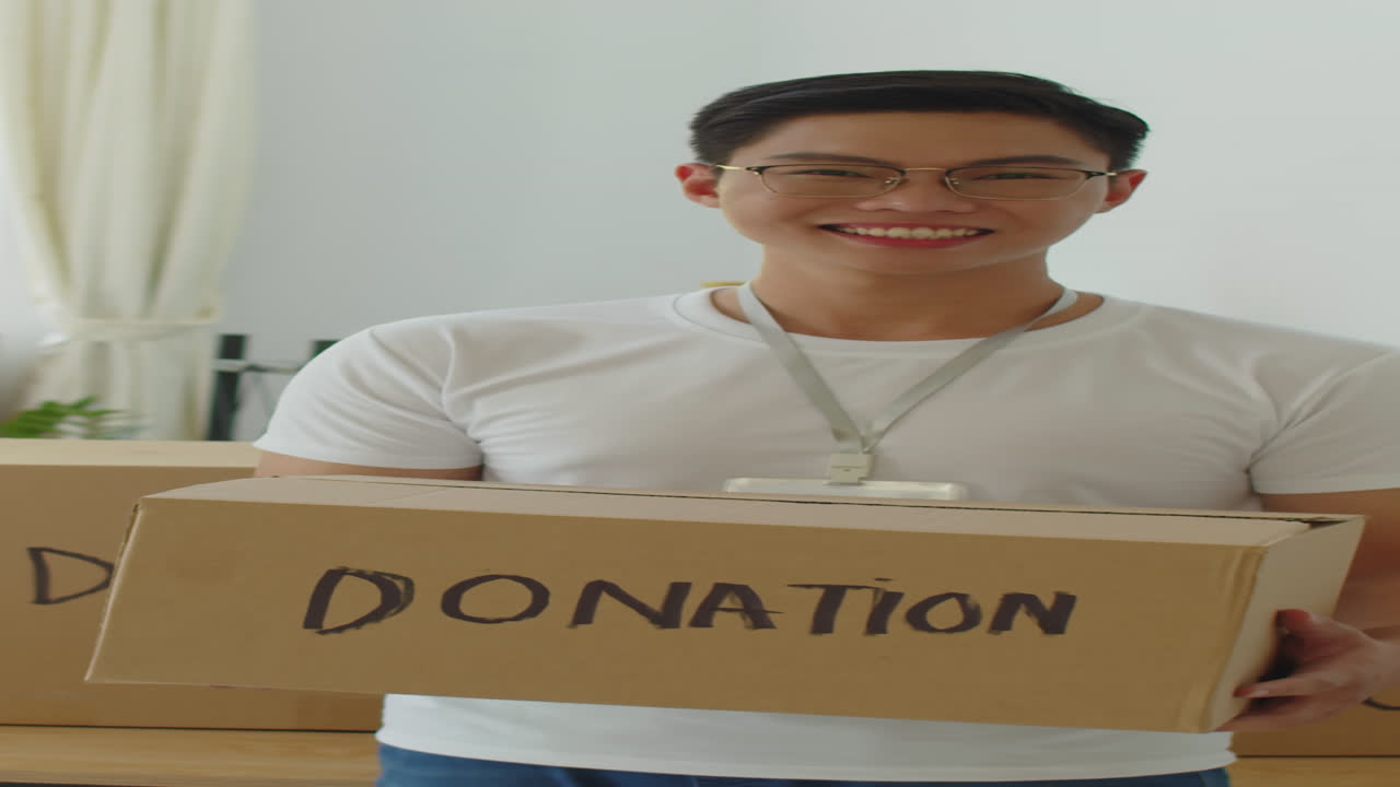 Vertical Portrait of Gen Z Volunteer with Donation Box for People in Need