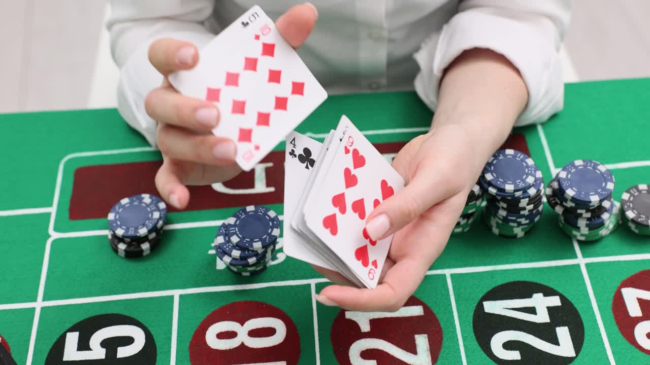 Playing cards and gambling with chips on a casino table