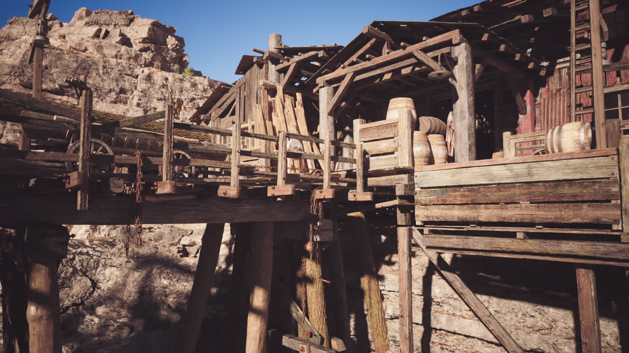 Rustic wooden mining structures at a historic site during bright daylight