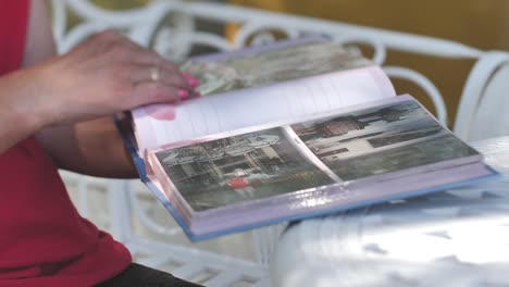 photo album with photo memories in the hands of women