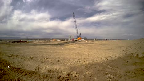 construction-of-a-building-from-concrete-panels,-these-are-lifted-by-a-crane-in-this-loopable-time-lapse