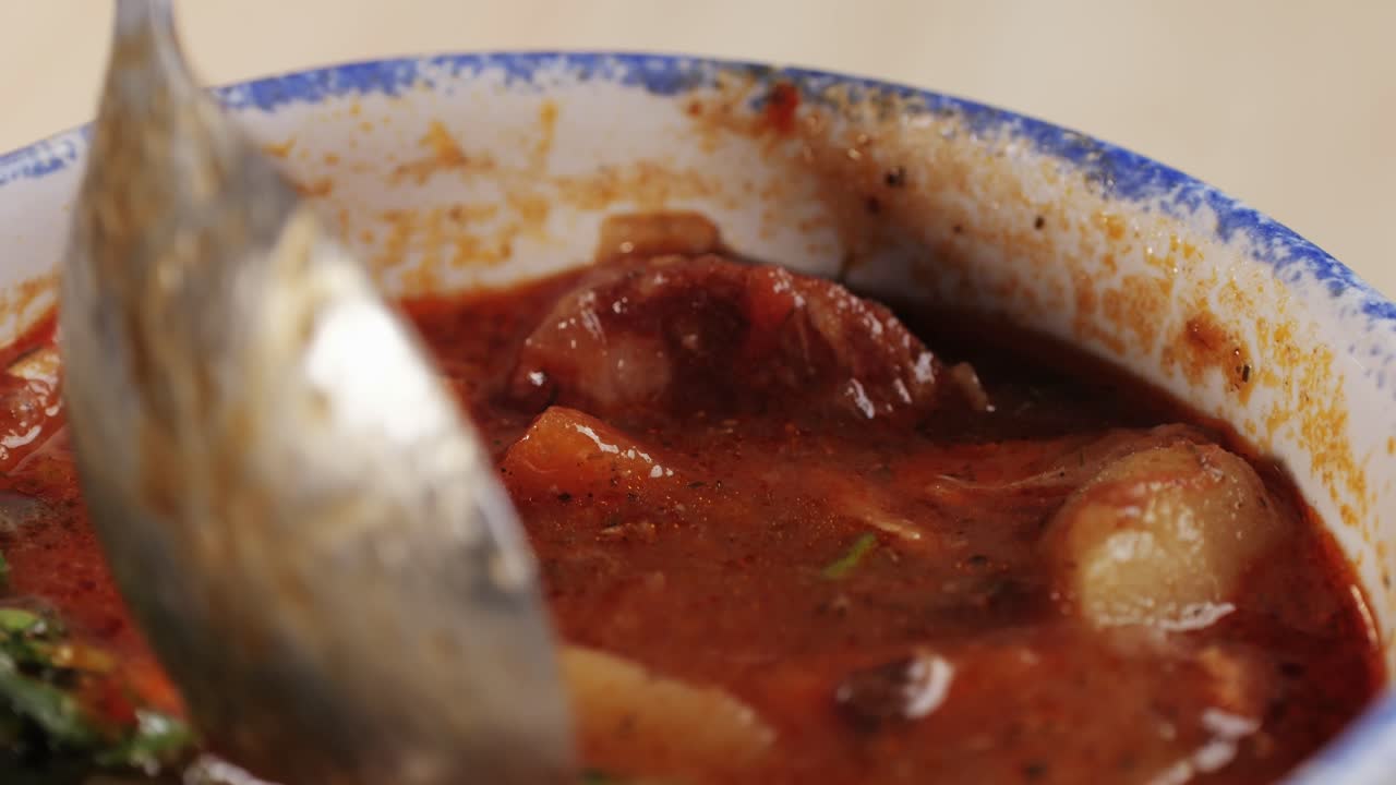Goulash soup with potato, carrot, meat and bolgarian papper and parsley cilantro in top. Shurpa soup. High quality 4k footage