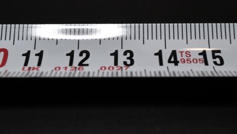 tape measure. sliding shot along tape. macro shot. close up.