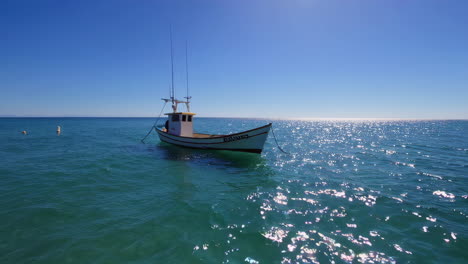 small fishing boat on calm ocean water