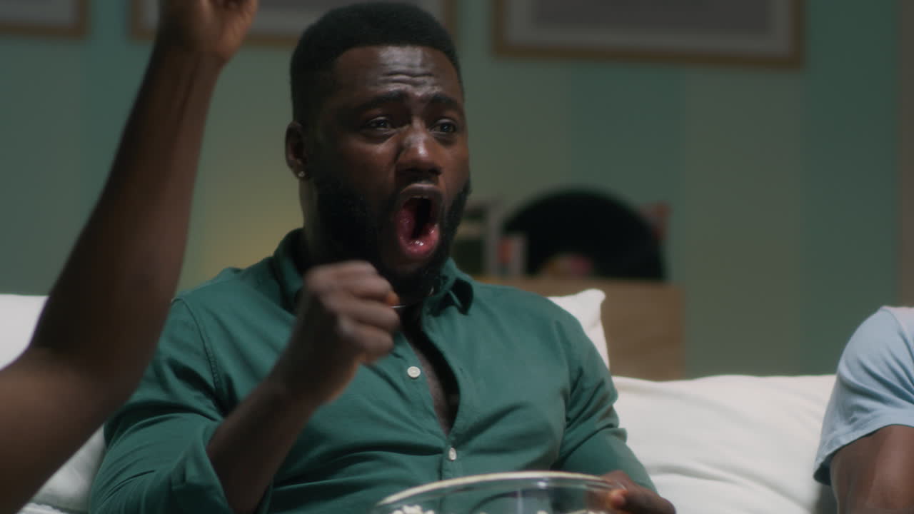 Friends Watching TV and Celebrating a Win