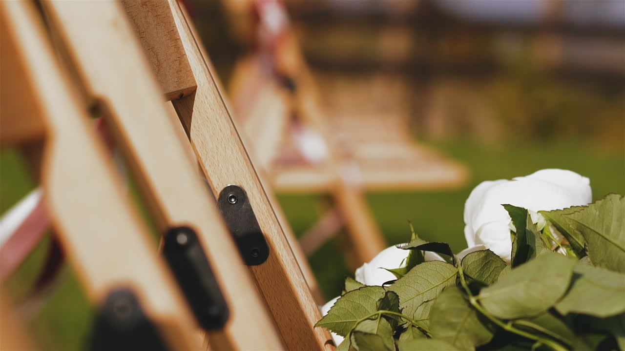 rose bouquet on chair with ribbons waved by wind at venue