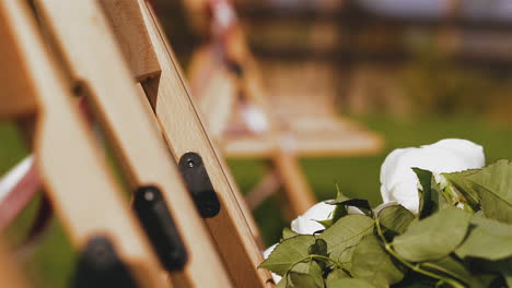 rose bouquet on chair with ribbons waved by wind at venue